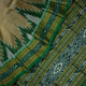 Elegant styling of a brown and green Khandua silk saree with butta work as draped on a model.