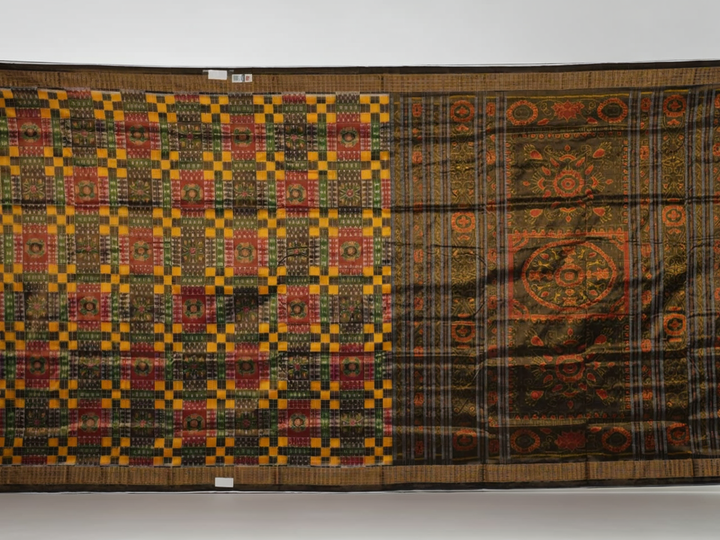 Extreme close-up of Sambalpuri Silk Saree fabric, revealing multi-color brown weave and tissue texture.