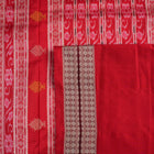 Extreme close-up revealing the rich Bomkai silk fabric texture and intricate handloom weave details in white and red.