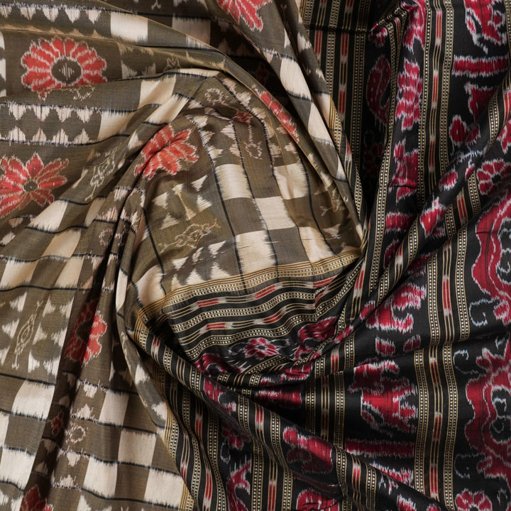 Close-up of the luxurious silk fabric texture and handloom weave of the grey and black Sambalpuri saree.