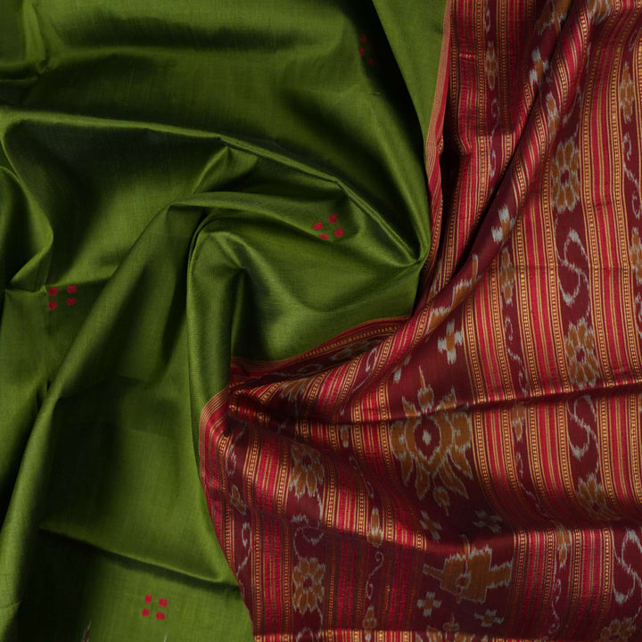 Model draped in a green and red Khandua silk saree with traditional butta work and rich border.