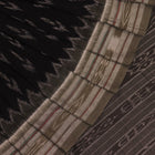 Saree styled; black Sambalpuri cotton saree with grey motifs showcased in a draped presentation.