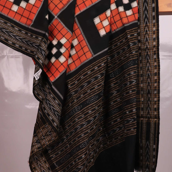 Rust and black Sambalpuri cotton dupatta with Pasapalli design draped gracefully showcasing its beauty