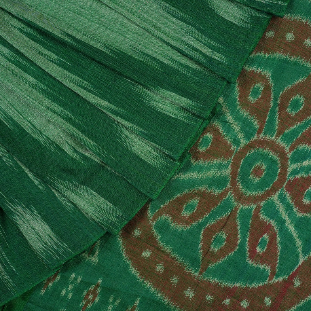 Model wearing a plain green Sambalpuri cotton saree styled elegantly to show the full handloom drape