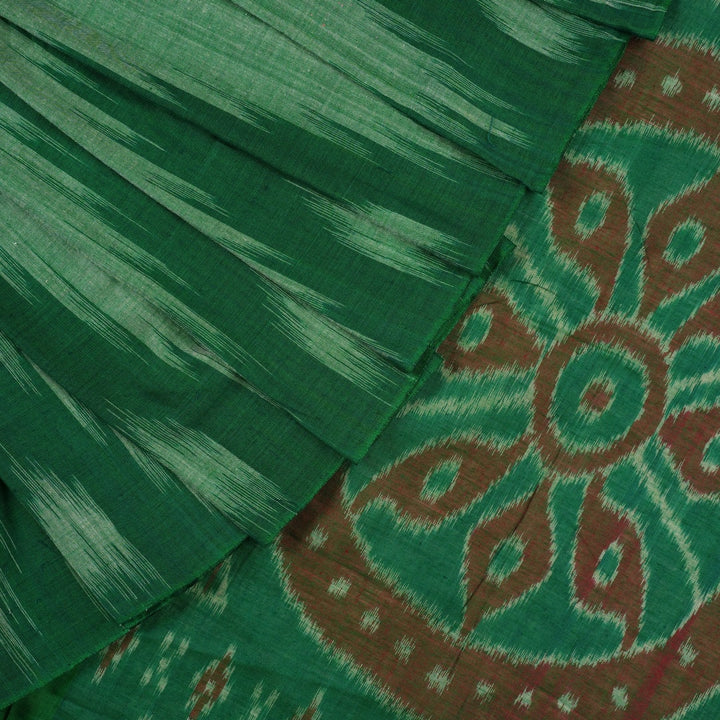 Model wearing a plain green Sambalpuri cotton saree styled elegantly to show the full handloom drape
