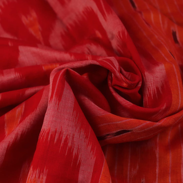 Red and yellow Sambalpuri cotton saree with motifs, elegantly draped to showcase its style.