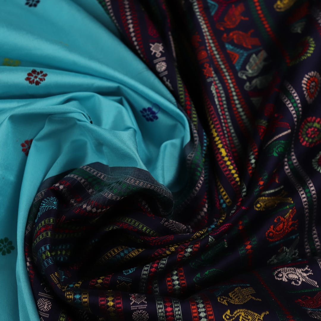 Close-up of light and dark blue silk fabric with intricate butta pattern woven in