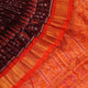 Close-up of maroon and orange Sambalpuri silk saree fabric texture, showcasing handloom weave and motif details.