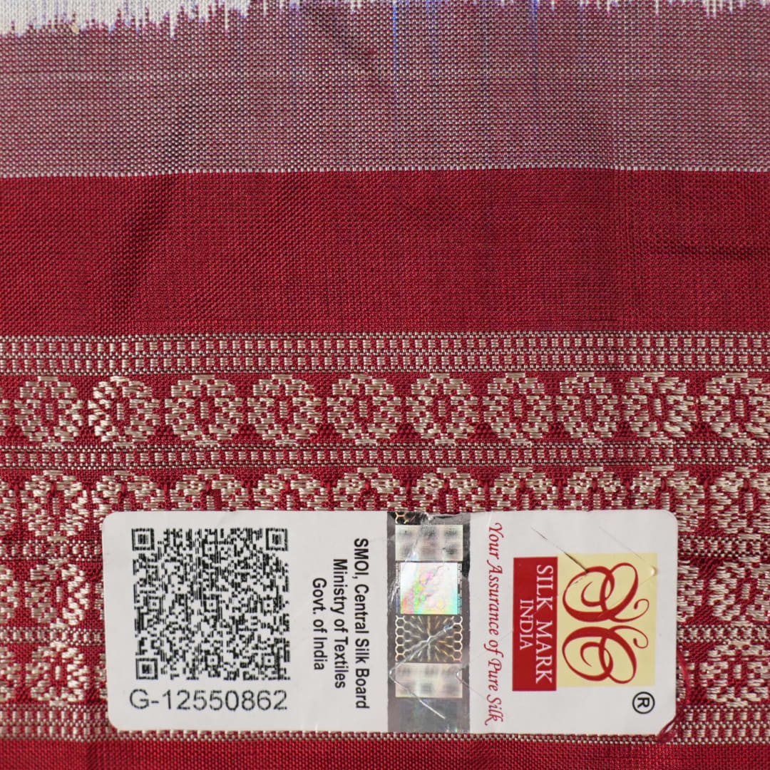 Close-up of the luxurious silk texture of the violet and maroon Sambalpuri Saree fabric.