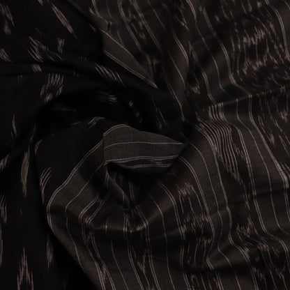 Saree styled; black Sambalpuri cotton saree with grey motifs showcased in a draped presentation.