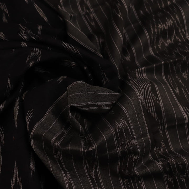 Saree styled; black Sambalpuri cotton saree with grey motifs showcased in a draped presentation.