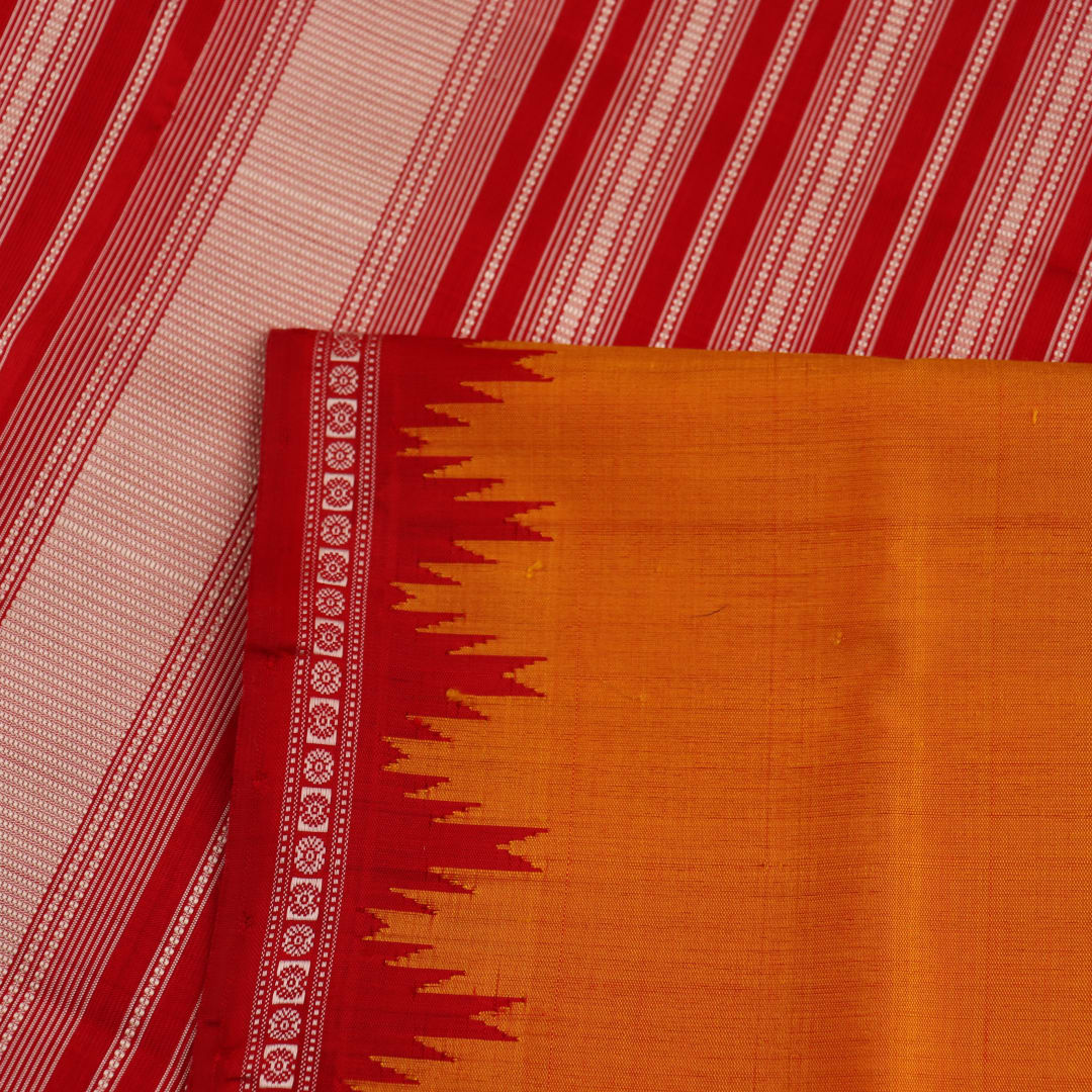 Close-up view of the smooth and lustrous silk fabric texture in a plain yellow Berhampuri saree.