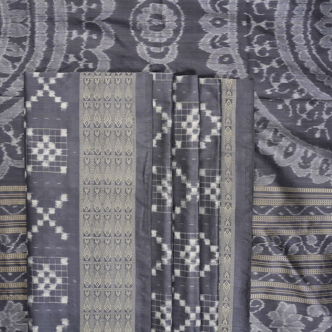 Close-up of the soft, luxurious grey Sambalpuri silk fabric texture with subtle weave details.