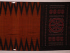 Brown and black plain Sambalpuri cotton saree elegantly draped.
