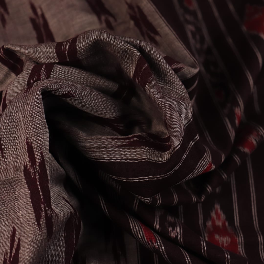 Elegantly draped grey Sambalpuri cotton saree with maroon motifs.