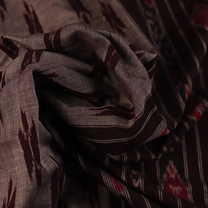 Elegantly draped grey Sambalpuri cotton saree with maroon motifs.