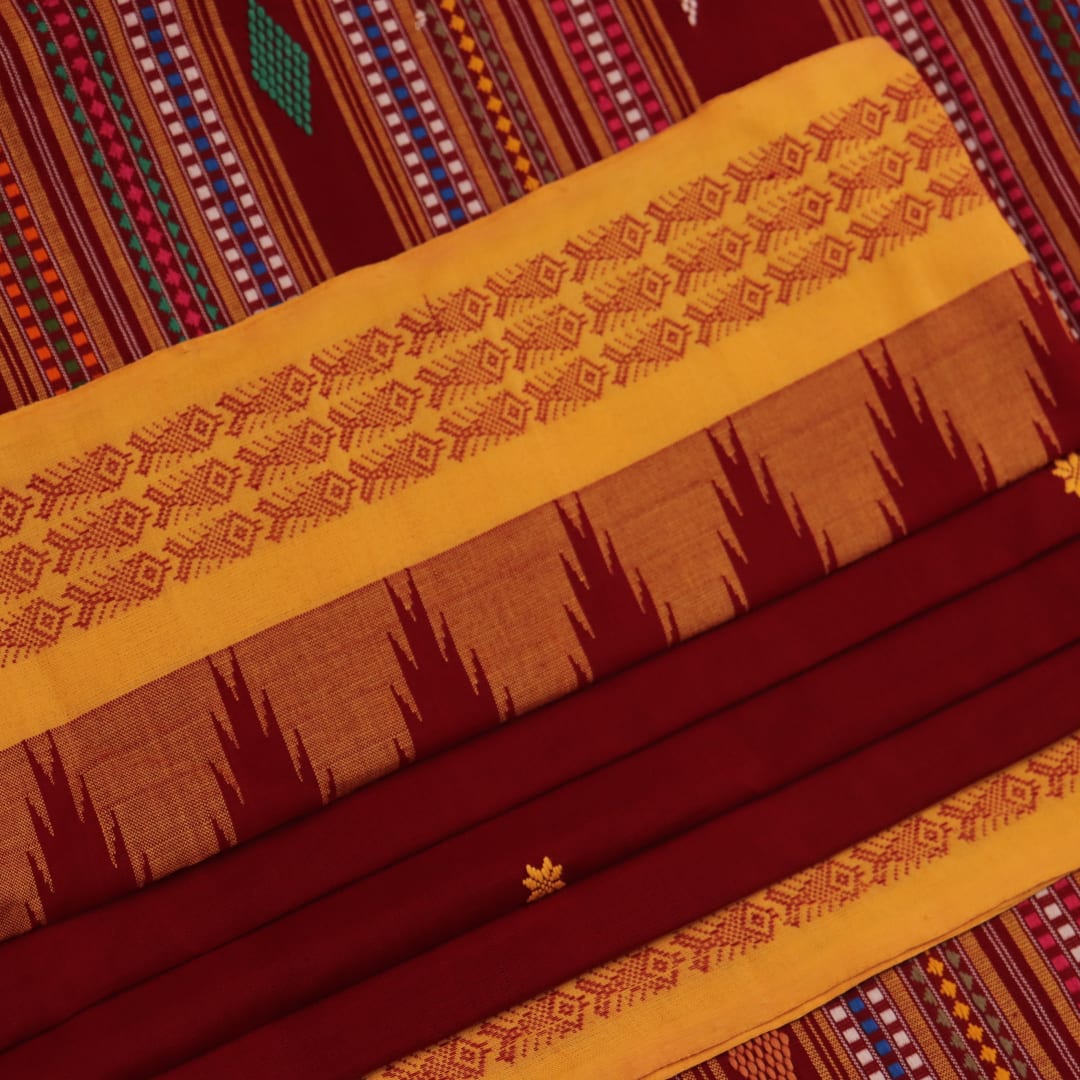 Full view of a maroon and yellow cotton Berhampuri saree with butta pattern.