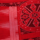 Styled plain pink and red Sambalpuri cotton saree, highlighting its elegant drape and material flow.