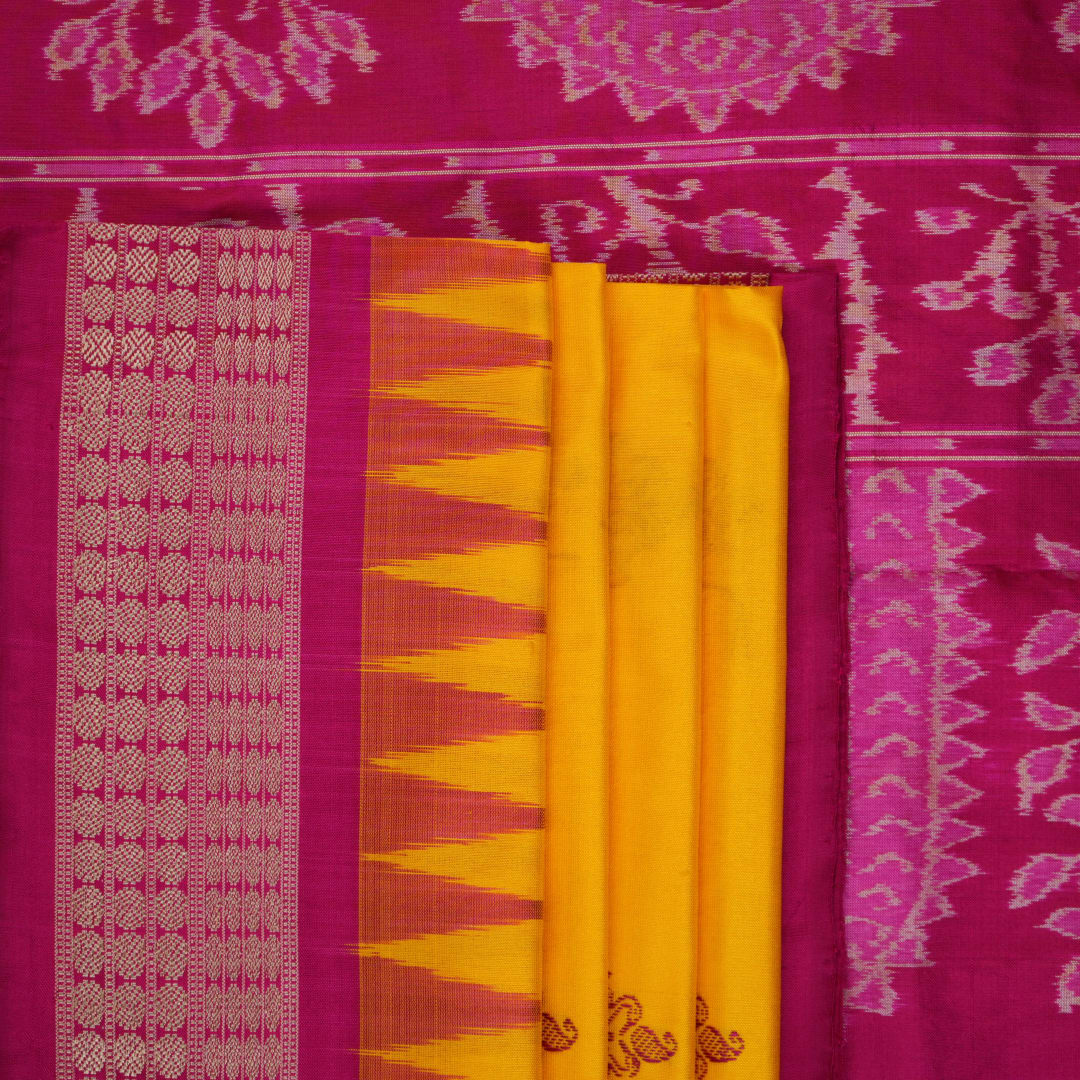 Close-up of the Bomkai Silk Saree's yellow fabric, revealing its luxurious texture and handloom weave.