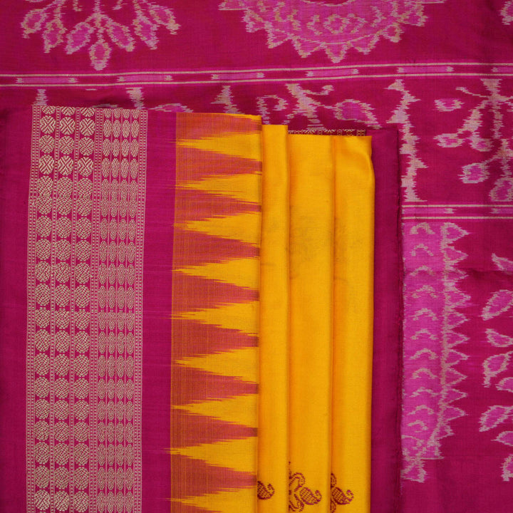 Close-up of the Bomkai Silk Saree's yellow fabric, revealing its luxurious texture and handloom weave.