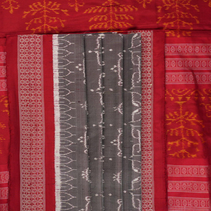 Close-up of the soft, lustrous grey Sambalpuri silk fabric texture, highlighting the intricate weave and motifs.