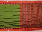 Green Khandua silk saree draped, showcasing its butta pattern and red accents.