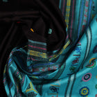 Close-up view of intricate butta pattern on the silk fabric of the black Dolabedi saree