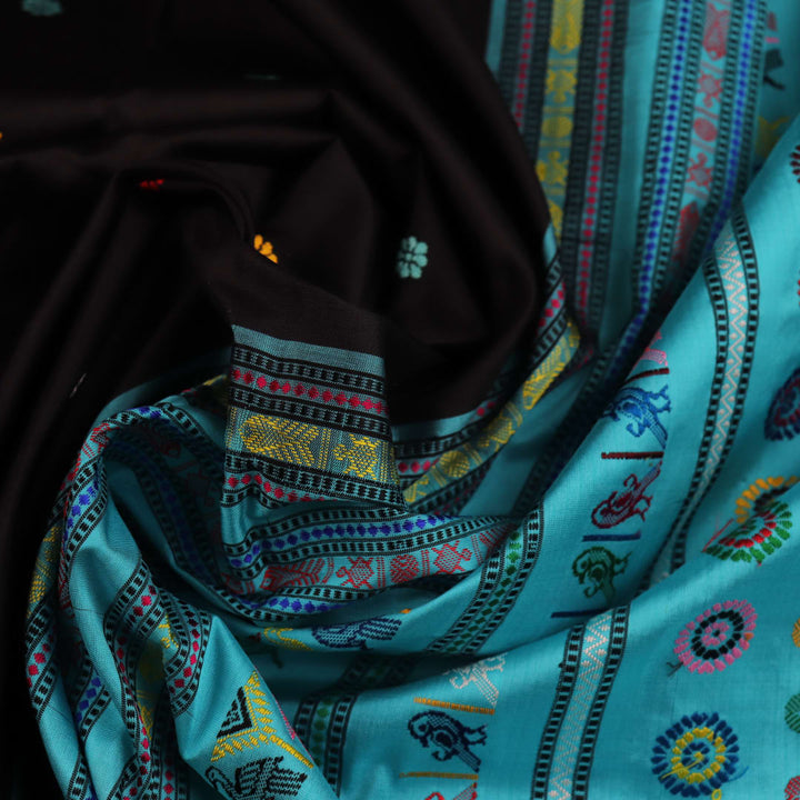 Close-up view of intricate butta pattern on the silk fabric of the black Dolabedi saree