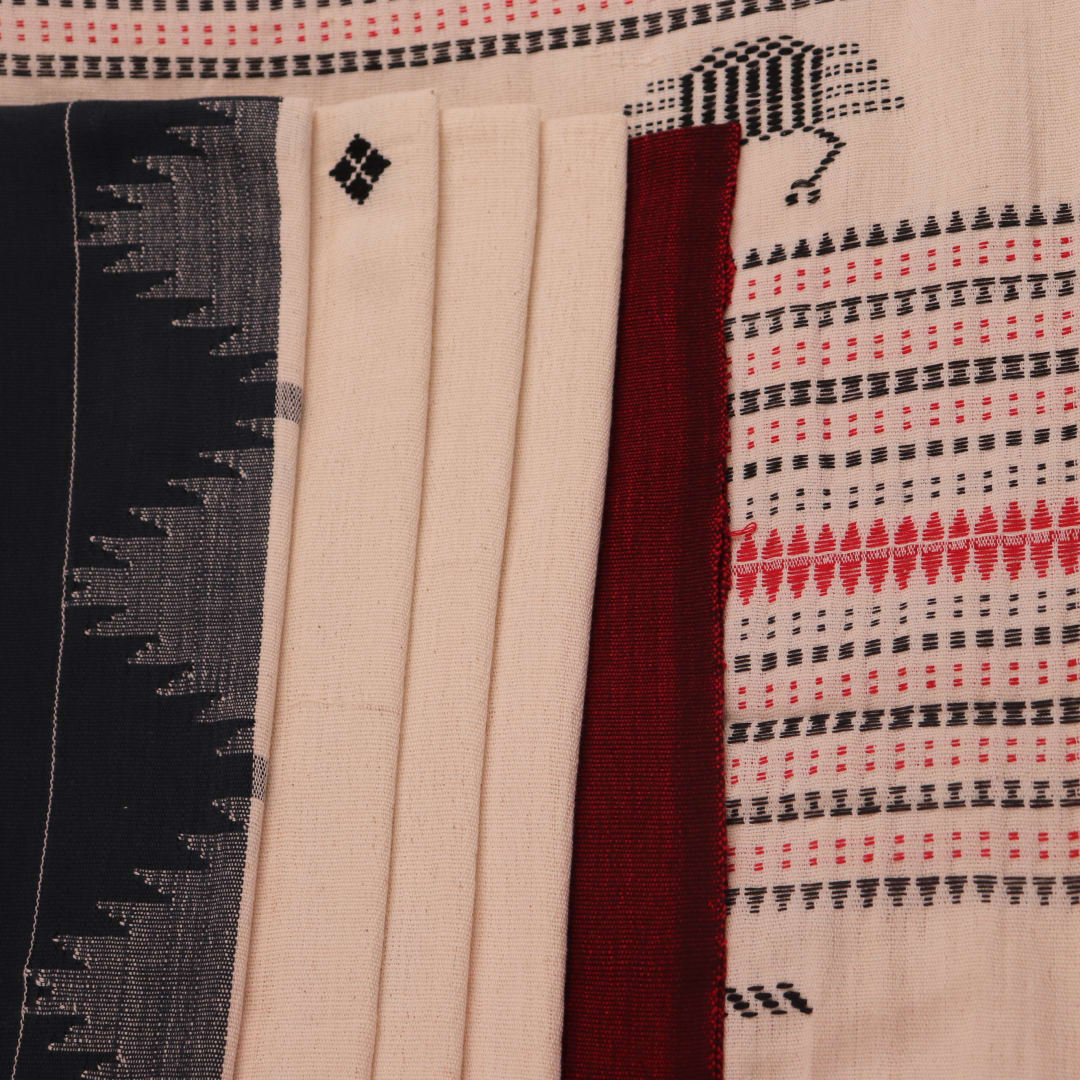 Full view of a white cotton Kotpad saree with a maroon border and butta pattern