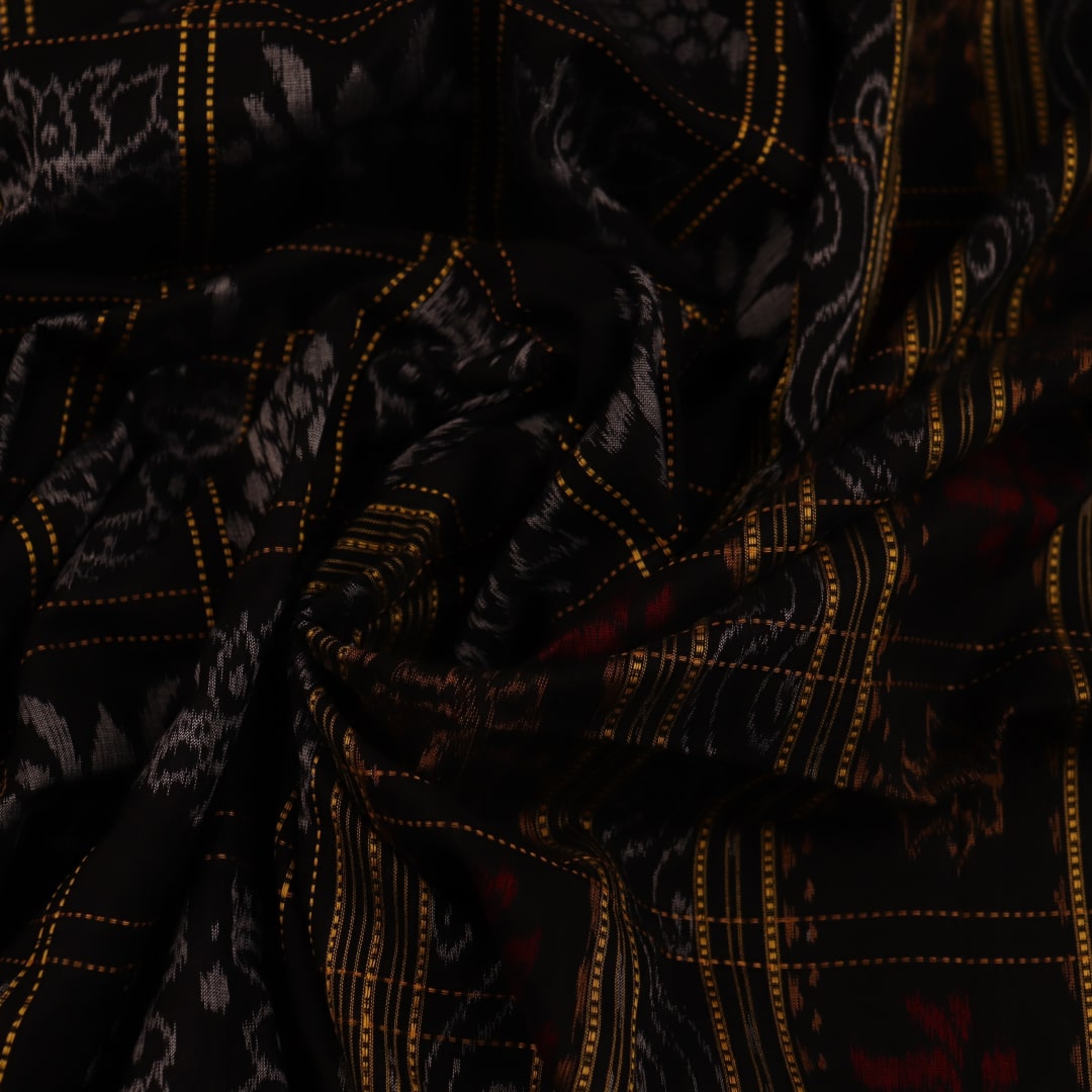 Full view of a black and black cotton Sambalpuri saree with intricate motif patterns.