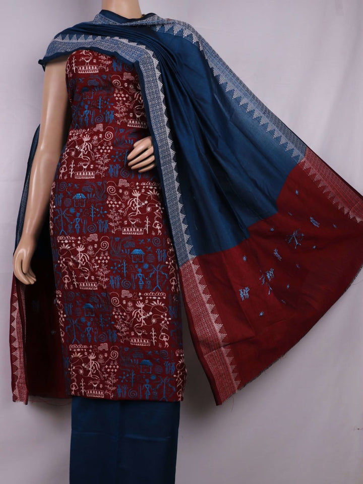 Close-up view of maroon and blue cotton Sambalpuri dress material, showcasing intricate doll pattern.