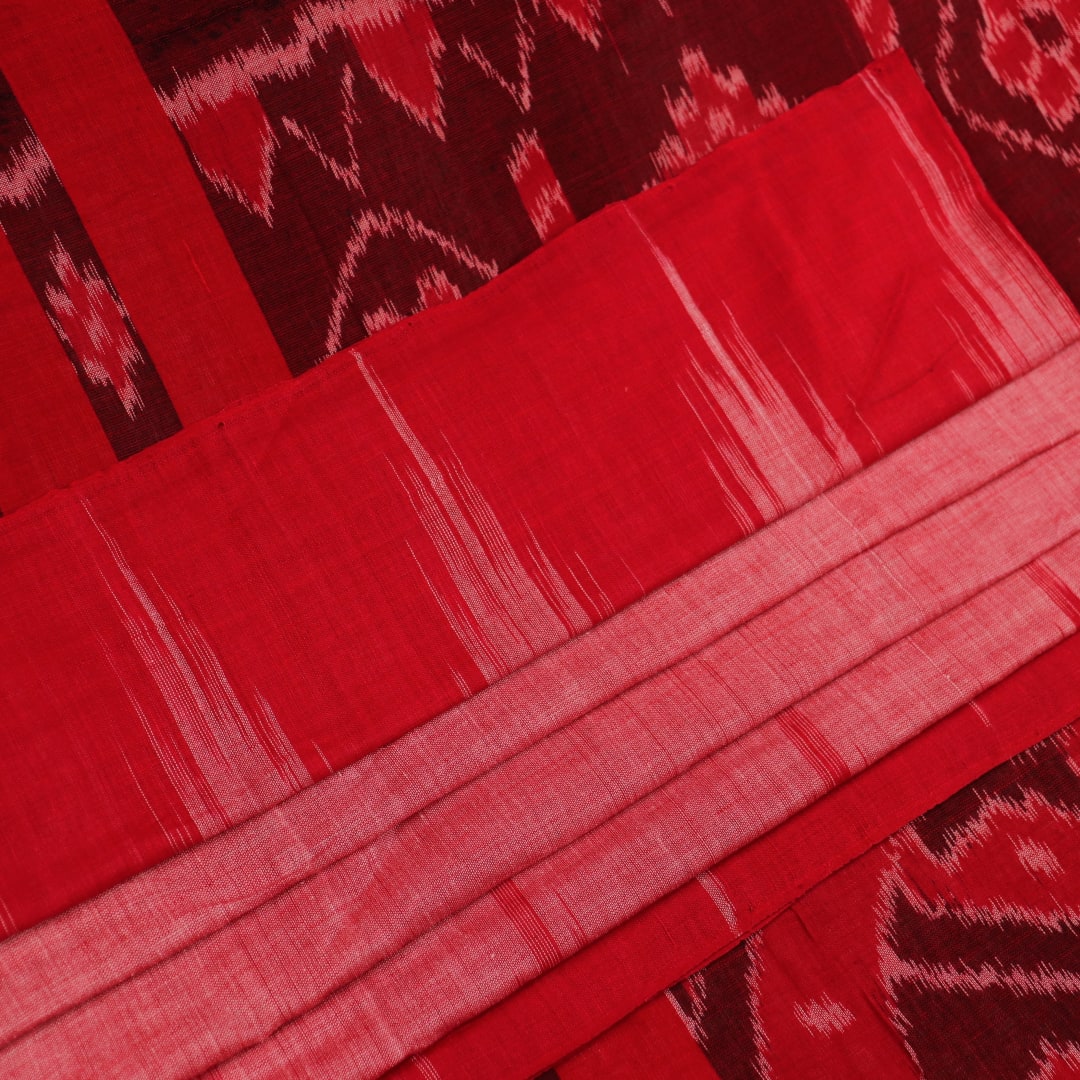 Pink and red Sambalpuri cotton saree draped; showcases overall look and styling with motifs visible.