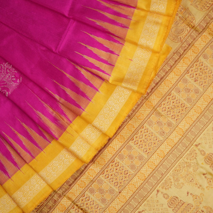 Close-up of the luxurious Bomkai silk saree fabric texture and weave in pink and yellow.