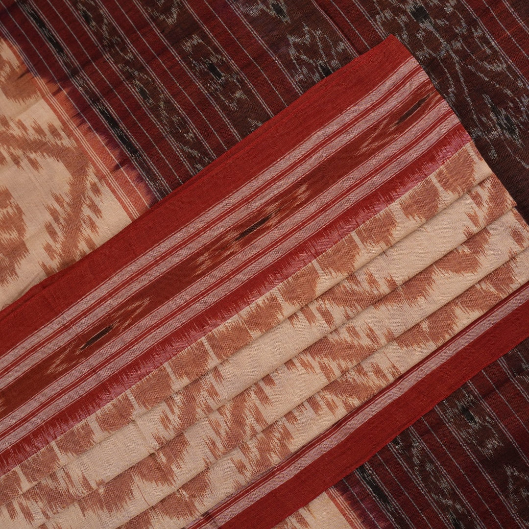 Traditional styling of a cream and rust Sambalpuri cotton saree draped on a model for a classic look.