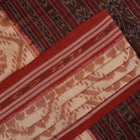 Traditional styling of a cream and rust Sambalpuri cotton saree draped on a model for a classic look.