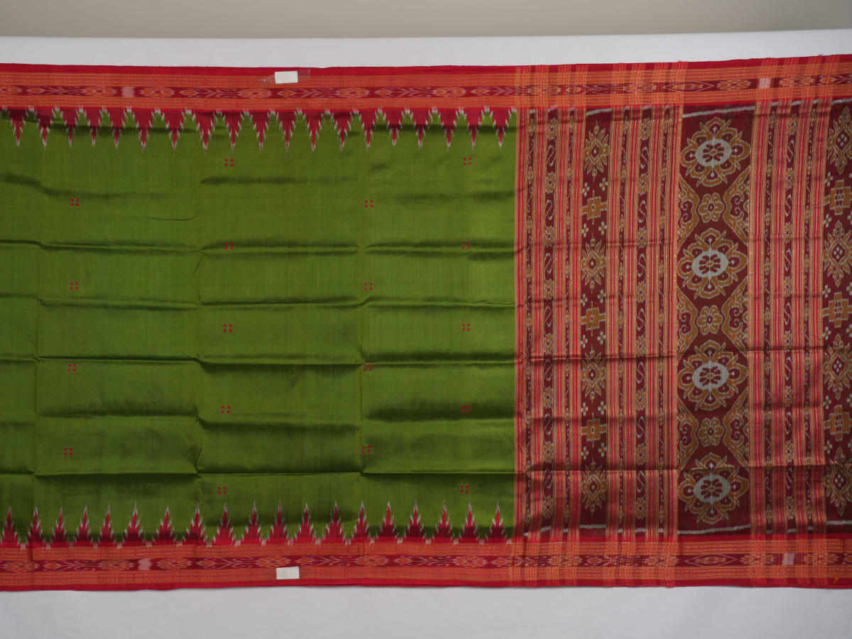 Model draped in a green and red Khandua silk saree with traditional butta work and rich border.
