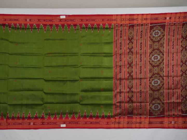 Model draped in a green and red Khandua silk saree with traditional butta work and rich border.