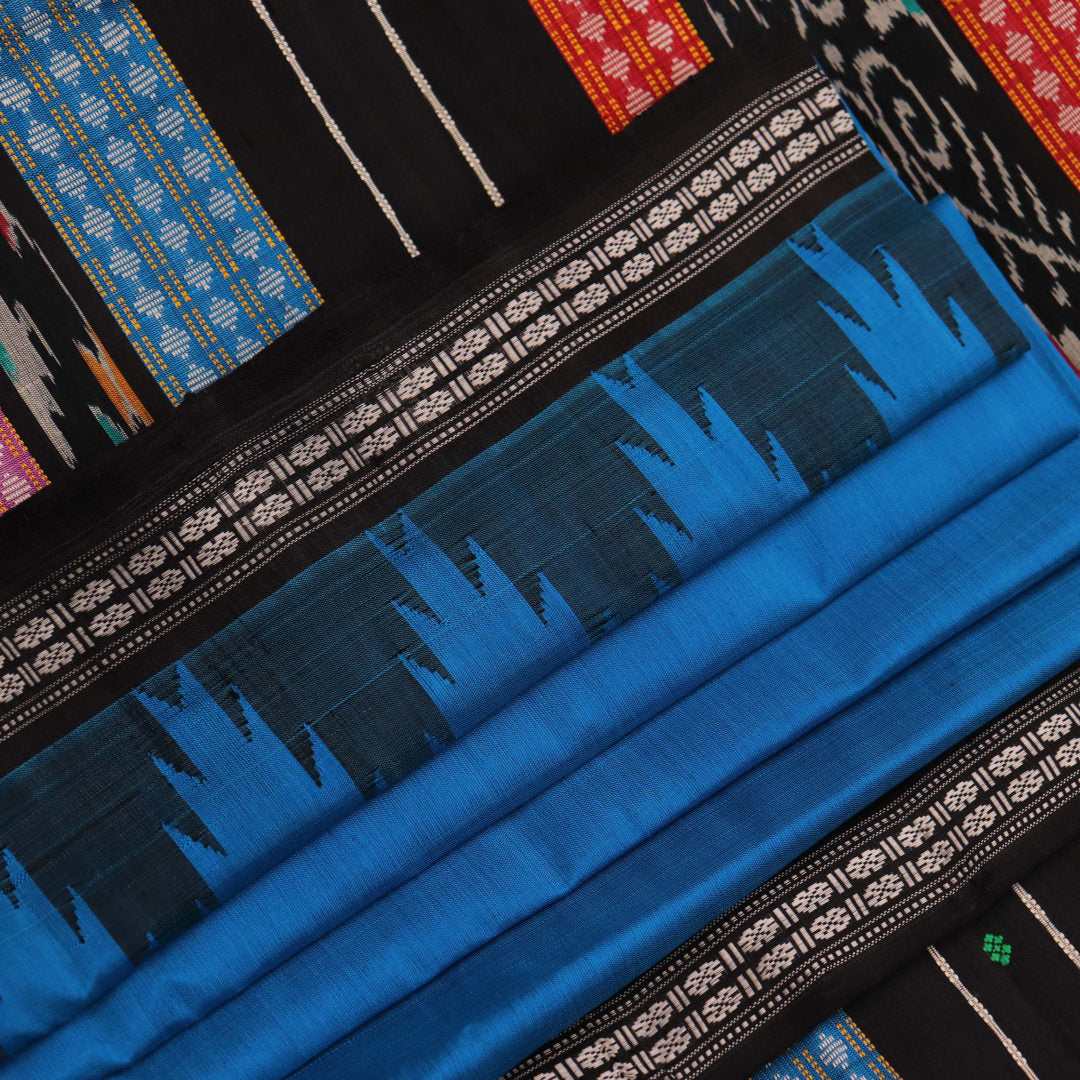 Close-up of intricate butta pattern on a silk blue and black Berhampuri saree