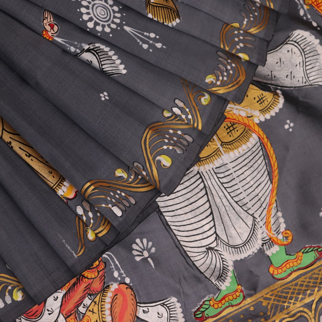 Close-up of handloom grey silk Patachitra saree fabric texture, revealing the intricate details of the hand-painted design.
