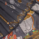 Close-up of handloom grey silk Patachitra saree fabric texture, revealing the intricate details of the hand-painted design.