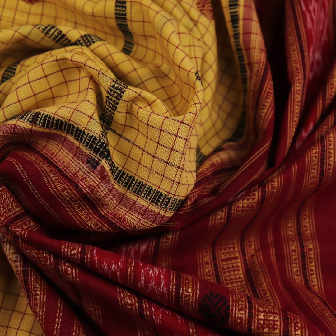 Full view of yellow and maroon cotton Sambalpuri saree featuring a butta pattern.