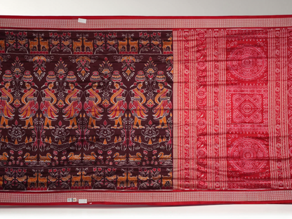 Close-up of the maroon Sambalpuri silk saree fabric, highlighting its luxurious texture and intricate weave.