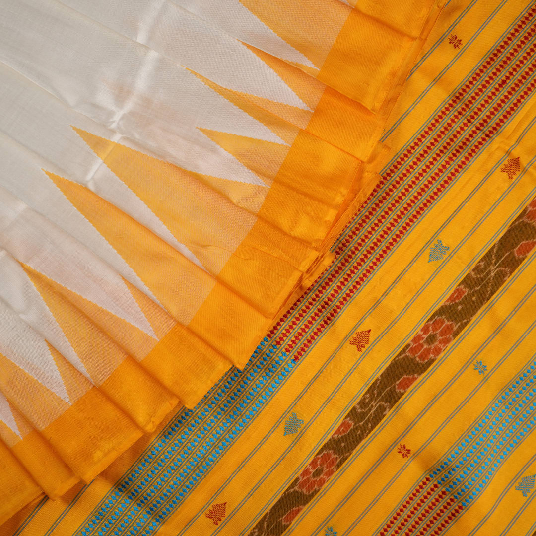 Close-up of the smooth texture and plain weave of white Sambalpuri silk fabric.