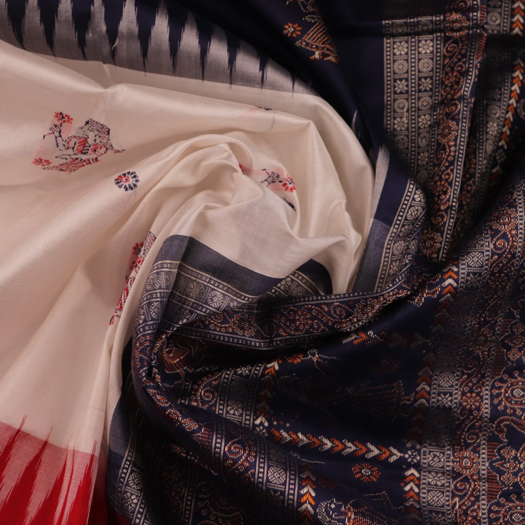 Image 7: Close-up view of the intricate silk fabric texture in white and red colors of a Bomkai saree