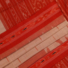 Cream and orange Sambalpuri cotton saree draped, showcasing traditional motifs and handloom texture.