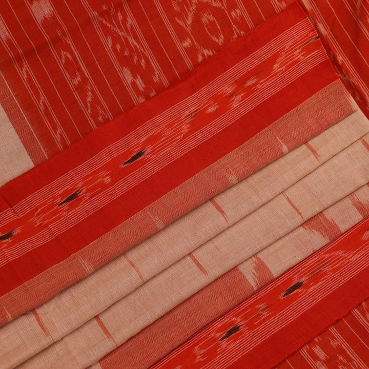Cream and orange Sambalpuri cotton saree draped, showcasing traditional motifs and handloom texture.