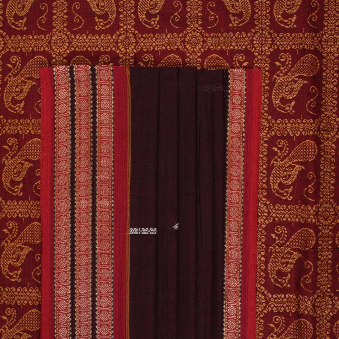 Full view of the maroon Bomkai cotton saree with red borders and small butta motifs laid out flat.