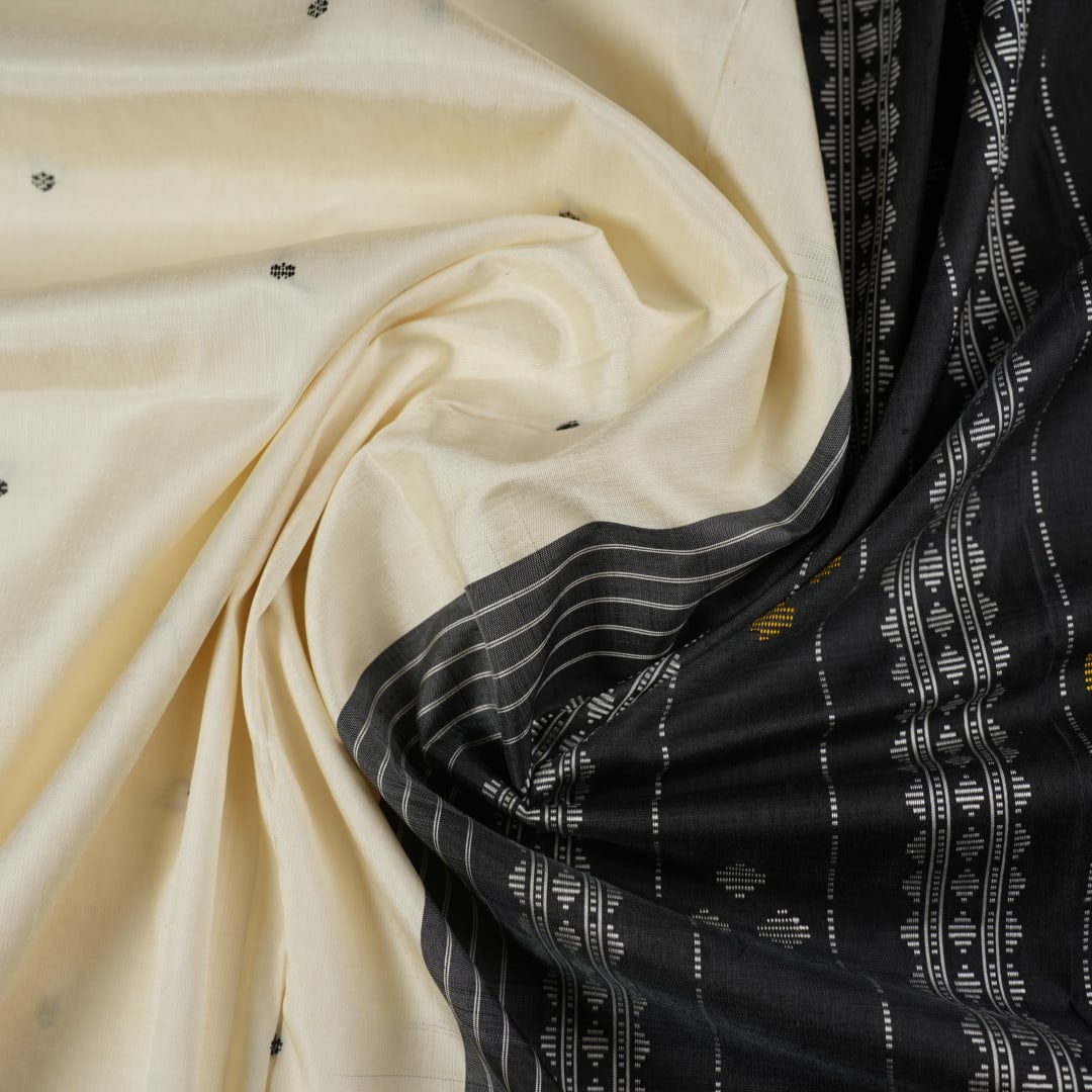 Close-up of the luxurious Berhampuri Silk Saree fabric, revealing the fine weave and soft texture.