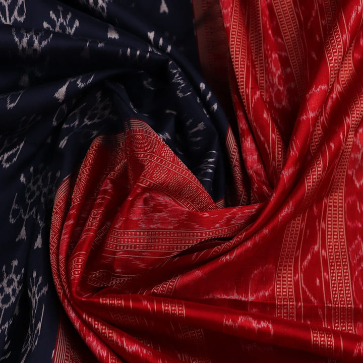 Close-up view of the blue silk Sambalpuri saree's fabric texture showcasing intricate motifs in red