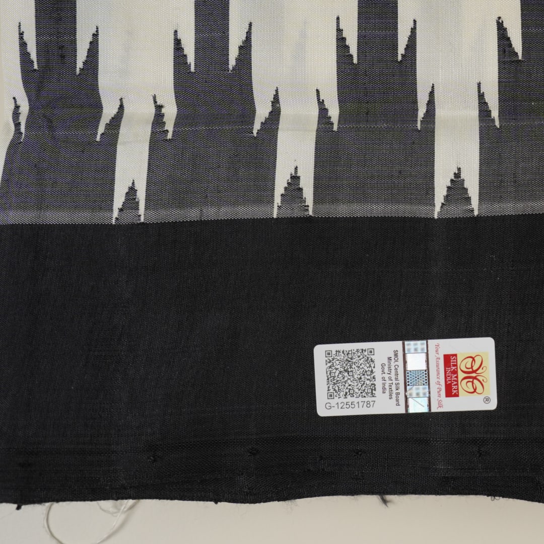 Close-up of the luxurious Berhampuri Silk Saree fabric, revealing the fine weave and soft texture.